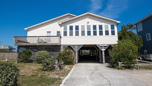 A two-story house with a covered driveway and a balcony. - Oceanside, 400 ft to Beach access, screened porch, SNH416, Ocean Adventure (Nags Head)