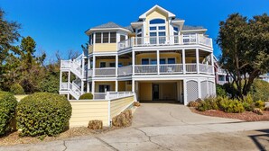 A multi-story house with a balcony, a driveway, and a well-maintained garden. - Oceanside, Private Pool, Hot Tub, Buck Island Amenities, BU21, Island Girl (Corolla)