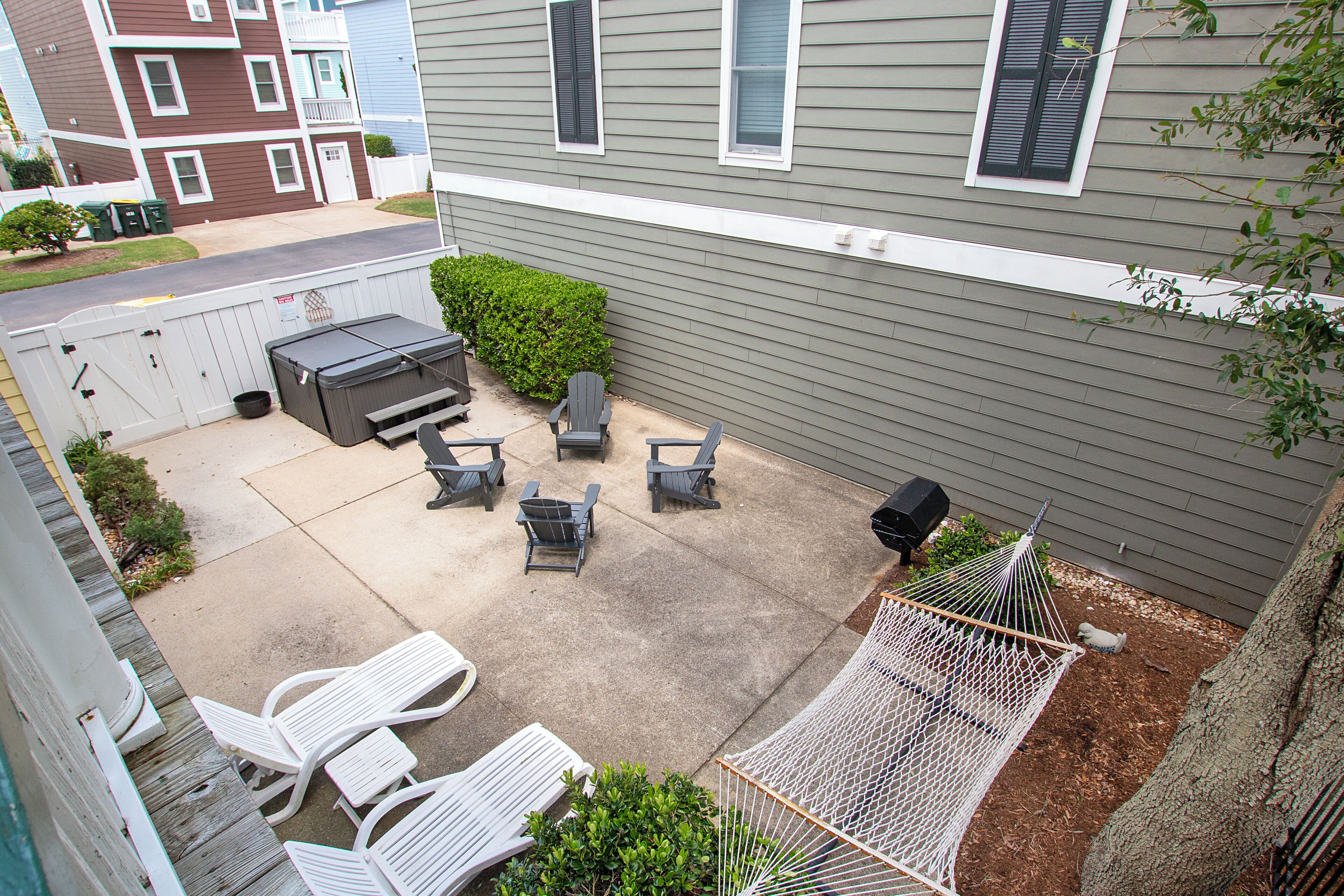A patio area with outdoor seating, a grill, and a hammock.