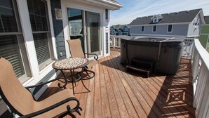 A wooden deck with a hot tub, a table, and chairs. - Oceanside, Dogs Welcome, Hot Tub, Close to Shopping, BU13A, Tropical Dreams A (Corolla)