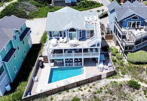 A two-story house with a pool, multiple decks, and outdoor seating areas. - OCEANFRONT, Private Pool, Hot Tub, Ocean Views, CP1, Sunny Delite (Corolla)