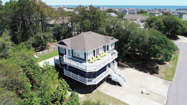A multi-story house with a balcony and outdoor seating. - Oceanside, Comm Amenities, Priv Pool, Close to Beach, Rec Rm, 219, Turtle Cove (Corolla)