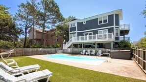 A two-story house with a swimming pool, outdoor seating, and a hot tub. - Oceanside, Comm Amenities, Priv Pool, Close to Beach, Rec Rm, 219, Turtle Cove (Corolla)