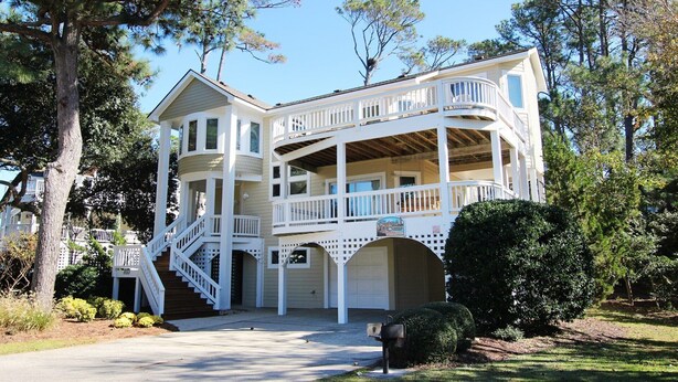 A two-story house with a balcony, a staircase, and a garage. - Soundside, Community Amenities, Sun Decks, 327, Footprints by the Sound (Corolla)