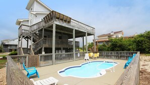 A backyard with a wooden deck, a swimming pool, and several lounge chairs. - Oceanside, Private Pool, Sun Decks, 660 ft to beach access! -WW951, Momma's Happy, Daddys Broke (Corolla)
