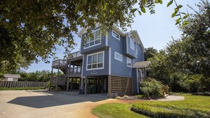 A two-story house with a covered porch and a deck. - Oceanside, Private Pool, Hot Tub, Screened Porch, 650 ft to Beach Access, WW1021, Zip-A-Dee-Dune-Dah (Corolla)