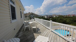 A wooden deck with outdoor furniture, a pool, and a view of neighboring houses. - Oceanside, 7 BRs, ELEVATOR, Private Pool, Hot Tub, OH3, Aurora (Corolla)