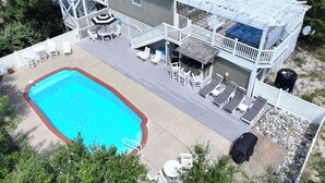 A two-story house with a swimming pool, outdoor seating, and a covered patio area. - Oceanside, Private Pool, Hot Tub, Close to beach access, 224, Its All Good (Corolla)