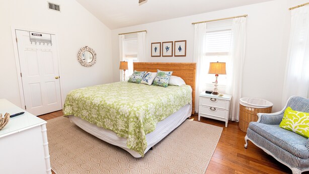 A bedroom with a bed, a nightstand, a chair, a dresser, and a door labeled 'PRIVATE.' - Oceanside, Private Pool, Hot Tub, Close to beach access, 224, Its All Good (Corolla)