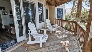 A covered porch with wooden railings and white Adirondack chairs. - Soundfront, Sound views! Dogs Welcome, Private Pool! 520, Bay Spray (Corolla)