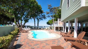 A pool area with lounge chairs and a view of the ocean. - Soundfront, Sound views! Private Pool, Community Amenities, 504, Lost N' Sound (Corolla)