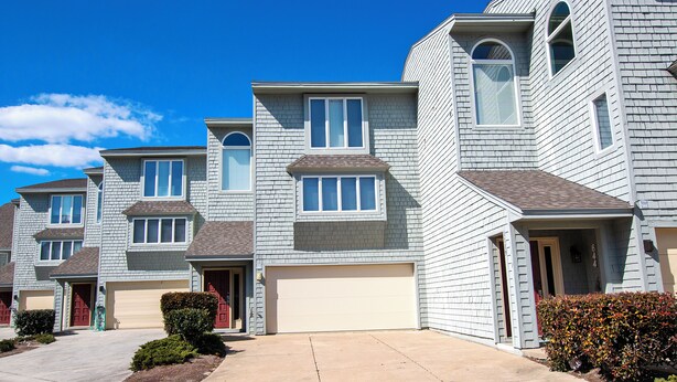 A row of townhouses with attached garages and a clear driveway. - Oceanside, close to beach, Community Pools, Community Tennis, 643, Ocean Dream (Corolla)