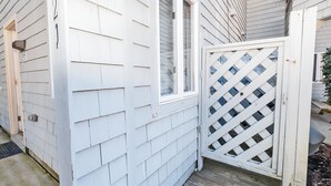 A white wooden house with a window and a lattice door. - Oceanside, close to beach, Community Pools, Community Tennis, 643, Ocean Dream (Corolla)