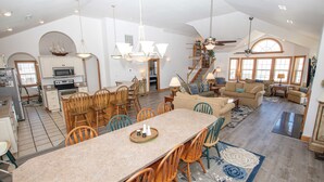 A spacious kitchen with a large island, wooden chairs, and a dining table. - Oceanside, Private Pool, Rec Room, Vllyball, PI157, Vintage Pine (Corolla)
