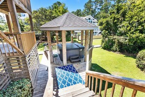 A wooden deck with a gazebo, a hot tub, and a patio area with a patterned rug. - Semi-Soundfront, Rec Room, Community Amenities, 533,Sound Secret (Corolla)