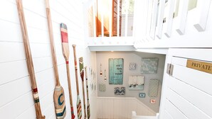 A narrow hallway with wooden paddles and a sign reading "PRIVATE" on the right. - Semi-Soundfront, Rec Room, Community Amenities, 533,Sound Secret (Corolla)