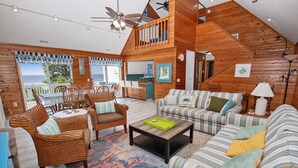 A spacious living area with a dining set, a sofa, and a coffee table.
