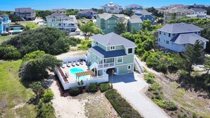 A multi-story house with a swimming pool, surrounded by other houses and a clear view of the ocean. - Oceanside, Pool, Hot Tub, 945 ft to Beach Access, WW935, Sea Watch (Corolla)