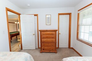 A bedroom with two beds, a dresser, and a framed picture on the wall. - Semi-Oceanfront, 7 BRs, Priv Pool, H Tub, Rec Rm, WL1068, Footloose (Corolla)