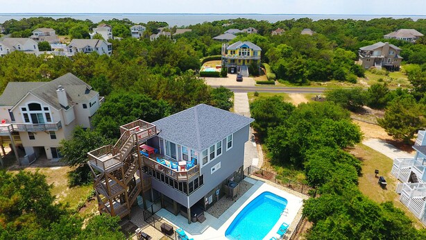 A large house with a pool, a deck, and a staircase leading to a balcony. - Oceanside, 4 BRs, Private Pool, Hot Tub, Screened Porch, WC955, La Carolina (Corolla)