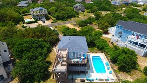 A residential property with a large deck, a swimming pool, and a two-story house. - Oceanside, 4 BRs, Private Pool, Hot Tub, Screened Porch, WC955, La Carolina (Corolla)