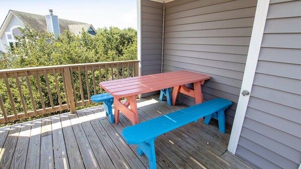 A wooden deck with a picnic table and benches. - Oceanside, 4 BRs, Private Pool, Hot Tub, Screened Porch, WC955, La Carolina (Corolla)