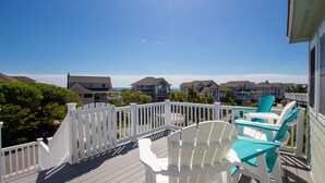 A wooden deck with white railings and turquoise Adirondack chairs. - Semi-Oceanfront, Private Pool with Cabana! Ocean Views! Pool Table, 126, Newmania (Corolla)