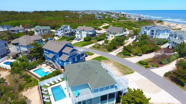 A residential area with houses, a swimming pool, and a beach in the background. - Semi-Oceanfront, Private Pool with Cabana! Ocean Views! Pool Table, 126, Newmania (Corolla)