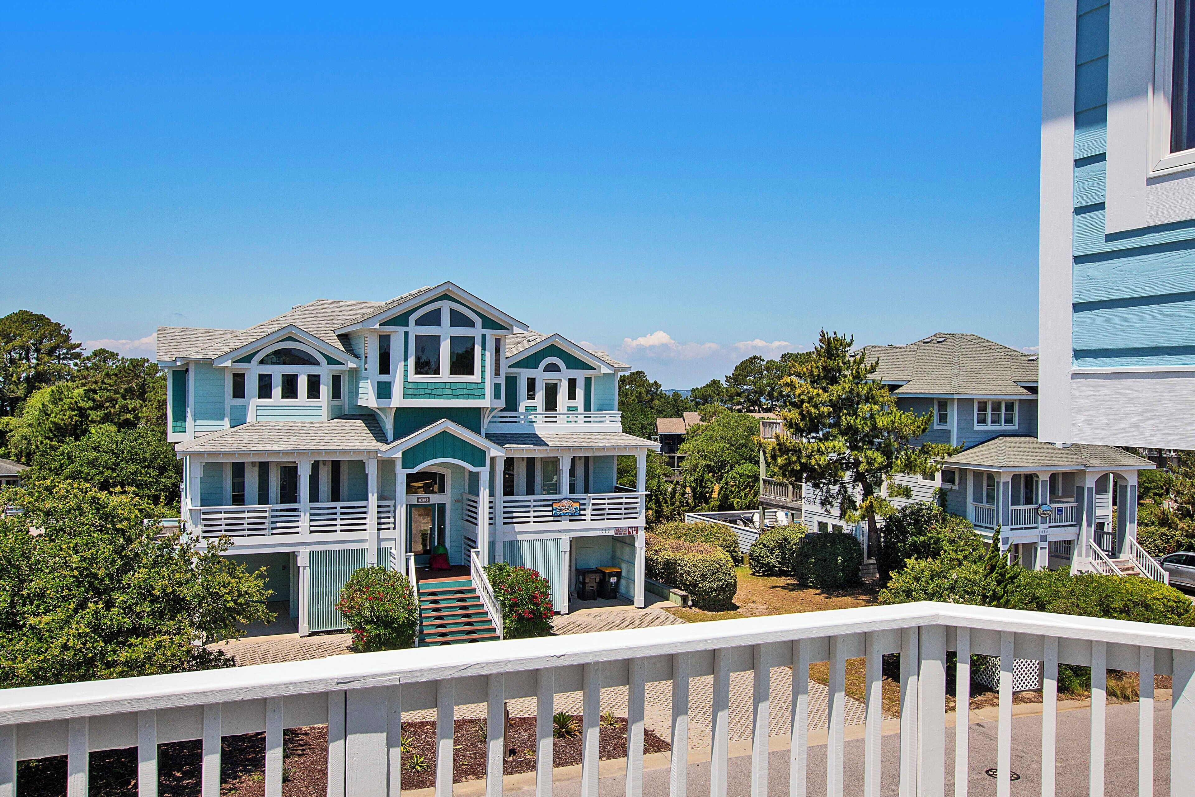 A two-story house with a balcony and a front porch.