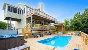 A wooden deck with a hot tub, pool, and outdoor seating area. - Oceanside, Pool, Hot Tub, Rec Rm, WC1005, Happily Ours (Corolla)