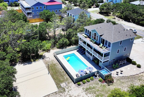 A two-story house with a swimming pool, outdoor seating, and a fenced yard. - Oceanside, Prv Pool, H Tub, Rec Rm, Sun Decks, WC887, Ashley's Nest (Corolla)