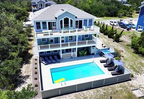 A multi-story house with a pool, outdoor seating, and a view of the surrounding area. - Oceanside, Prv Pool, H Tub, Rec Rm, Sun Decks, WC887, Ashley's Nest (Corolla)