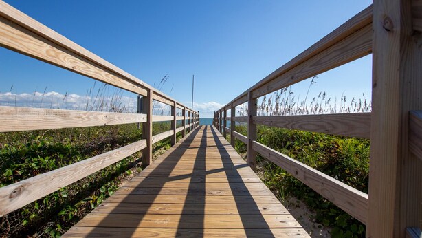 A wooden boardwalk leading to the sea with railings on both sides. - OCEANFRONT, Ocean Views, Sun Decks, Close to Beach Access, SA47, Lazy Bones (Duck)
