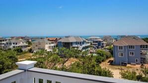 A coastal residential area with houses, a beach, and a clear sky. - Oceanside, Pool, Poolside Bar, Sun Decks, WC803, Believing is Sea-ing (Corolla)