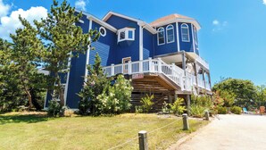 A two-story house with a balcony and a covered porch. - Oceanside, Pool, Poolside Bar, Sun Decks, WC803, Believing is Sea-ing (Corolla)