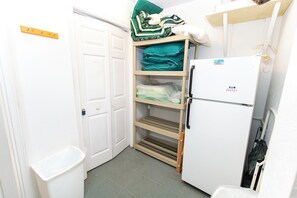 A compact kitchenette with a white refrigerator, a sink, and a small countertop. - Oceanside, Community Pool, Community Amenities, 677, Windswept II (Corolla)