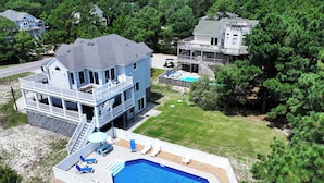 A two-story house with a swimming pool, a deck, and a fenced backyard. - Oceanside, Private Pool, Hot Tub, Sun Decks, WC1077, Seaside Manor (Corolla)