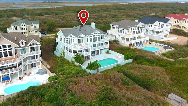 A large, multi-story beachfront property with multiple swimming pools and a large central pool. - OCEANFRONT, Pool, Ocean Views, Rec Rm, PI198, Key Largo (Corolla)