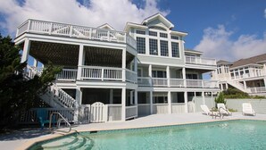 A multi-story beachfront property with a swimming pool, outdoor seating, and a staircase leading to the upper levels. - OCEANFRONT, Pool, Ocean Views, Rec Rm, PI198, Key Largo (Corolla)