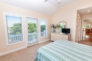 A bedroom with a bed, a dresser, a television, and a window with blinds. - Oceanside, Community Amenities, Prv Pool, Rec Rm, 5, Carolina on my Mind (Corolla)