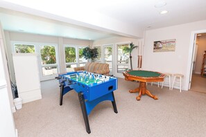 A room with a foosball table, pool table, and a sign for a bar. - Oceanside, Community Amenities, Prv Pool, Rec Rm, 5, Carolina on my Mind (Corolla)