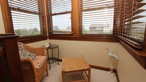 A corner room with a wicker sofa, a small table, and a chair. - Semi-Oceanfront, Close to Beach, Dogs Welcome, SA8, Berry (Duck)
