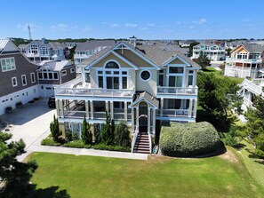 A large two-story house with a covered porch and multiple balconies.