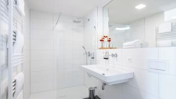 Shower, hair dryer, slippers, towels