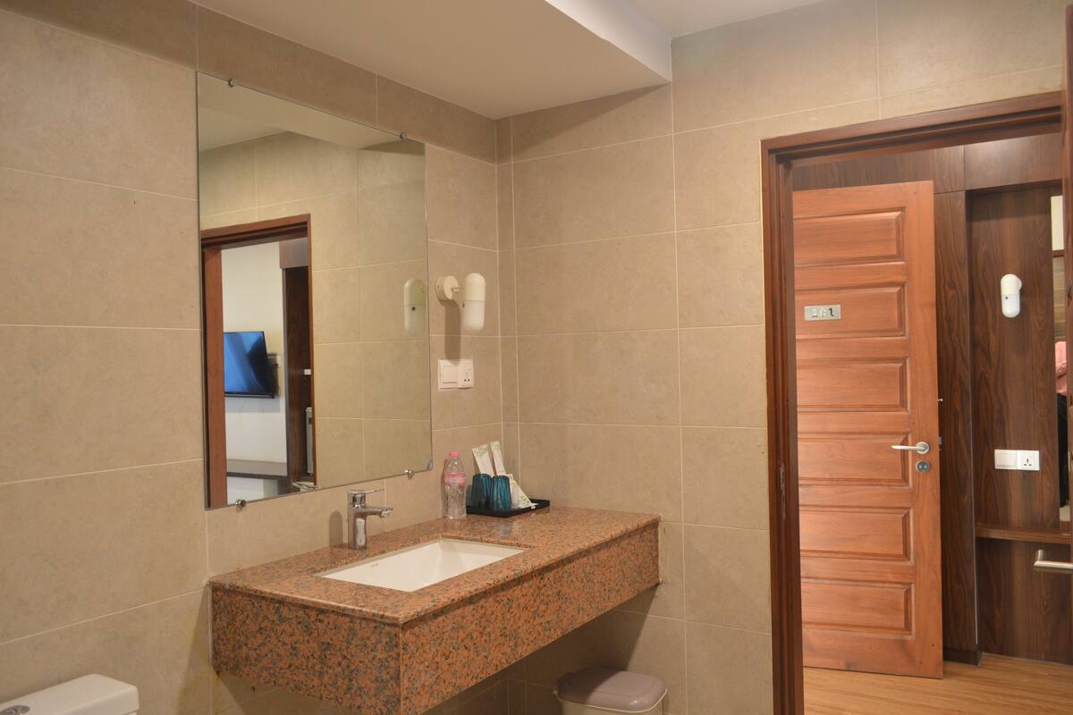 shower, slippers, towels, toilet paper