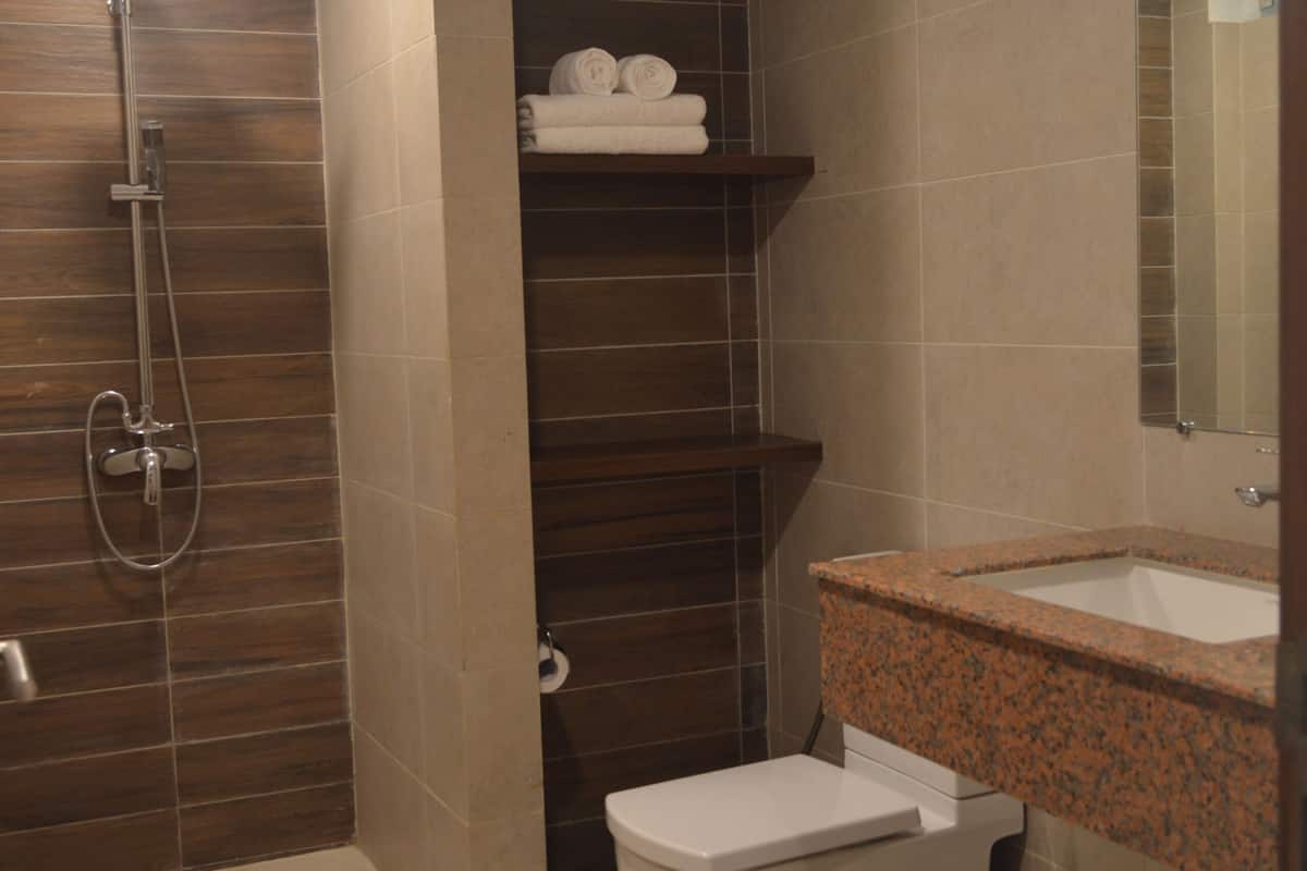 shower, slippers, towels, toilet paper