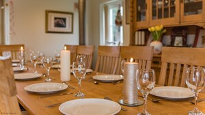 A dining table set for a meal with candles, glasses, and plates. - The Homestead by Bloom Stays - sleeps 17 (Canterbury)