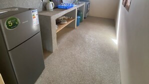 A compact kitchen with a refrigerator, a sink, and a window providing natural light. - Séné-Marra haven of peace.  (Cap Skirring)