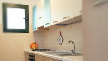Oven, coffee/tea maker, cookware/dishes/utensils, dining tables