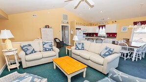 A living room with two sofas, a coffee table, and a dining area with a table and chairs. - Oceanside, Private Pool, Close to Beach Access and Shopping! KH1, Marabel-by-the-Sea (Kitty Hawk)